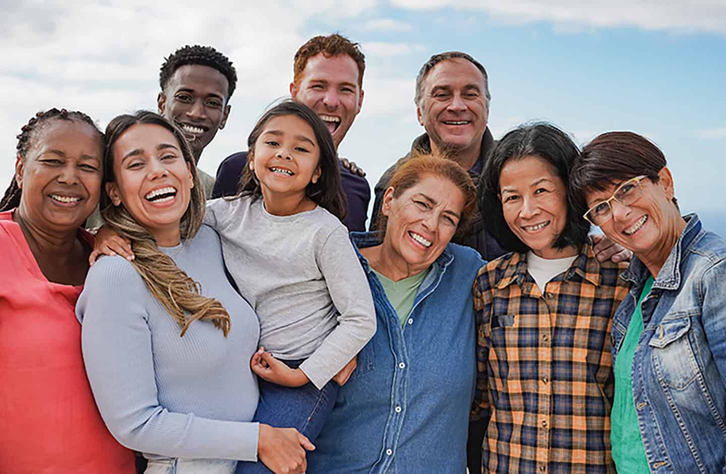group of adults and children laughing together