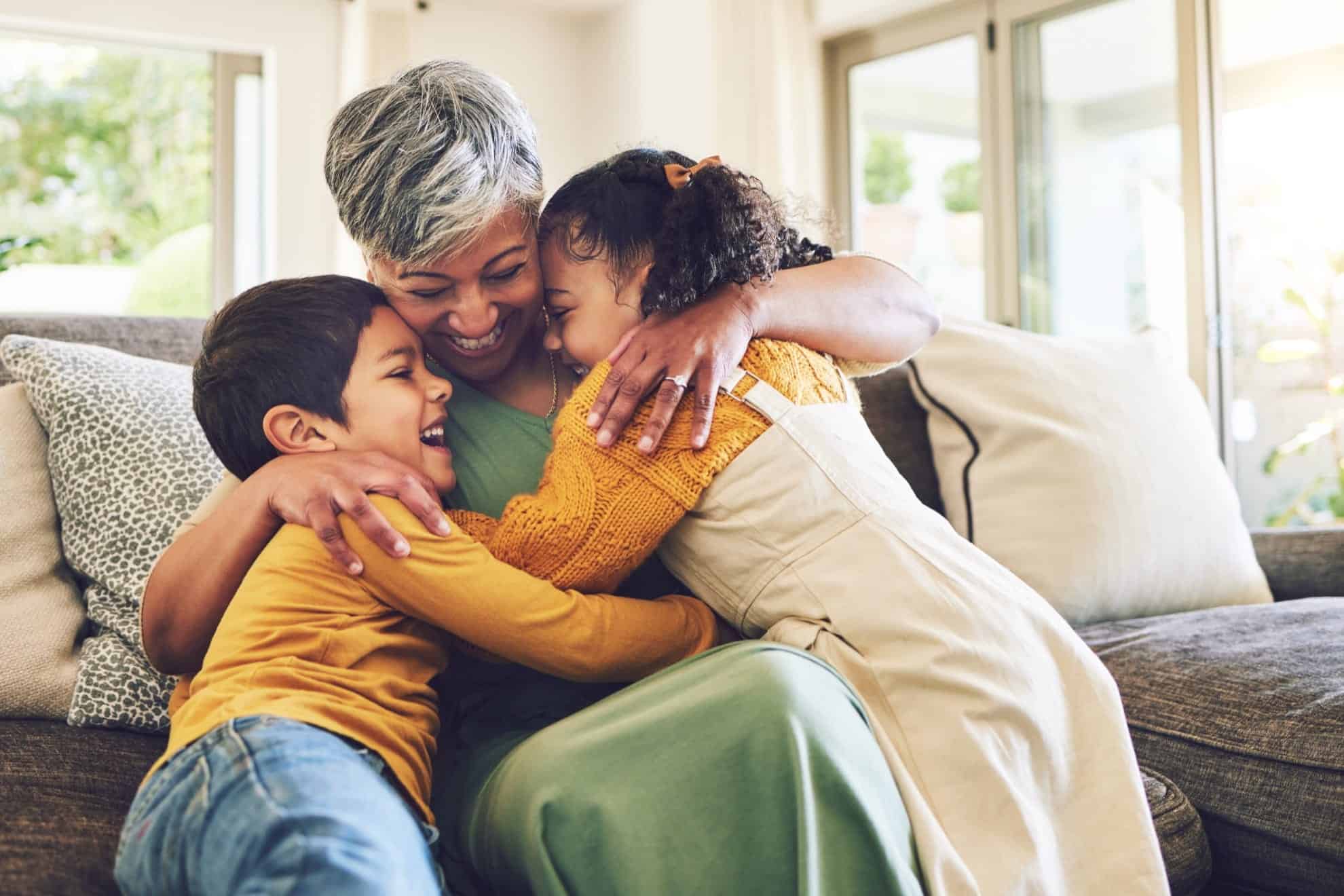 Family hugging, showing love and care in a warm home environment.