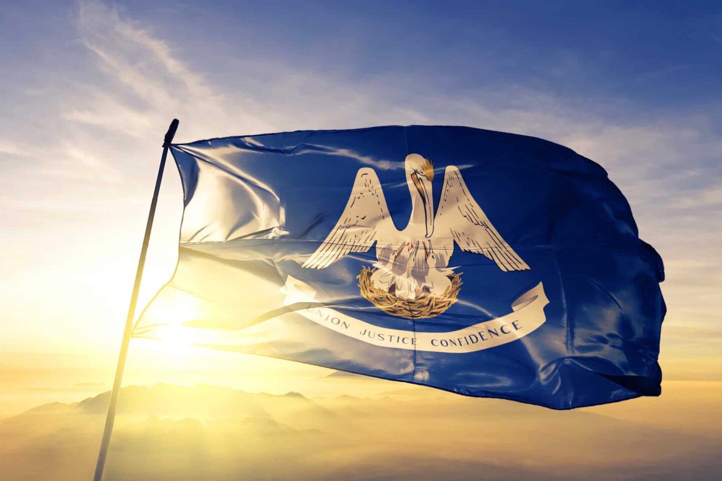 Louisiana state of United States flag waving on the top sunrise mist fog