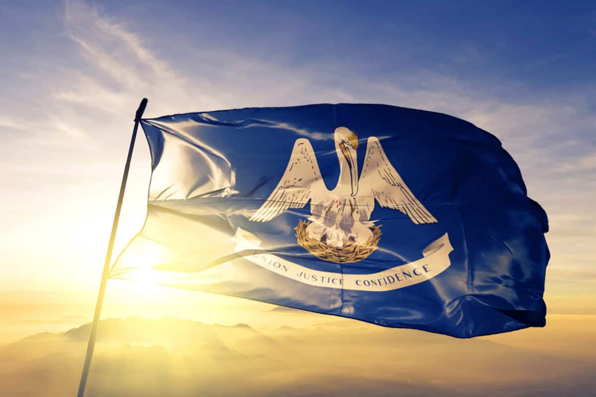 Louisiana state of United States flag waving on the top sunrise mist fog