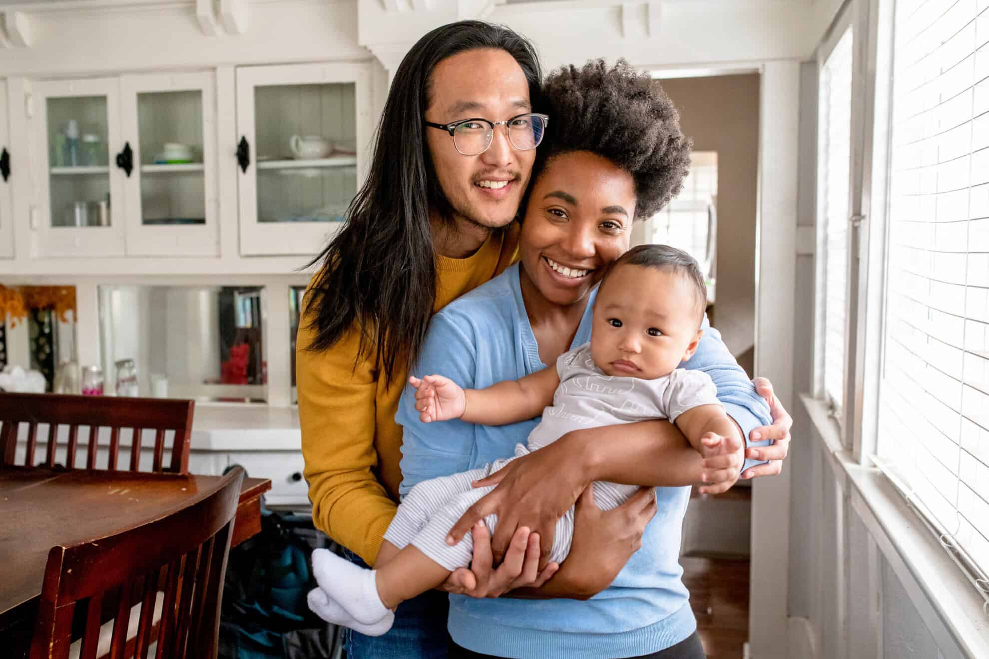 Happy multiethnic family with baby