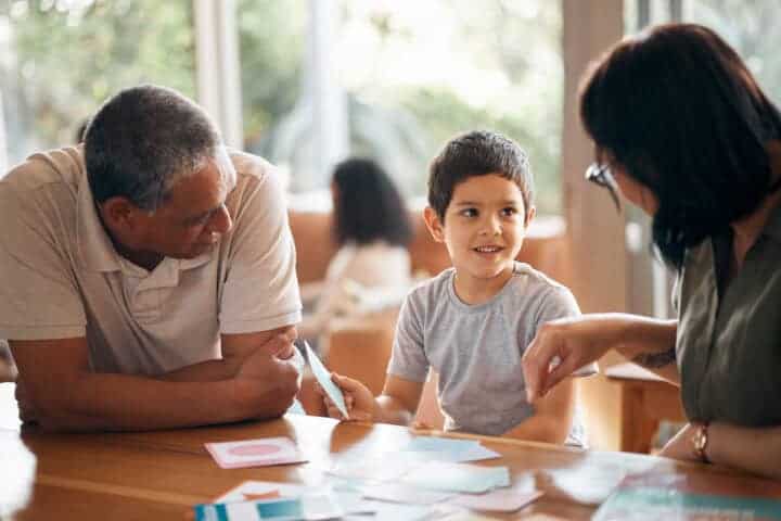 family with young child working together in classroom setting