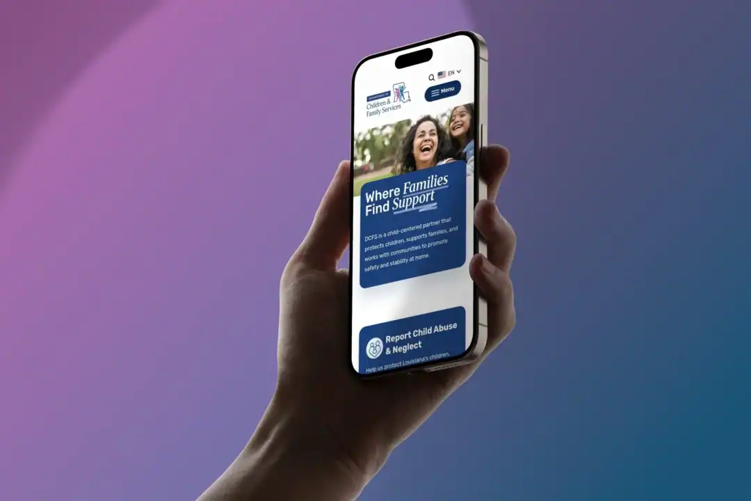 Screenshot of a person holding a phone with the DCFS.louisiana.gov website.